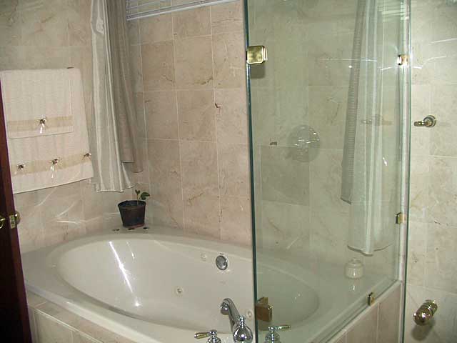 Bathroom Photo Example - simple bathroom with sand stone colored tiles and beige bath top