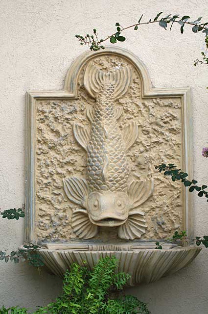 Little water fountain with a fish as its main deco design element, makes for a decorative element in any outdoor space