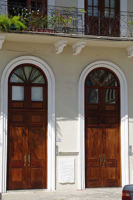 Photo of one two natural wood colored renovated very high old doors in the Colonial part of Panama City, Panama.