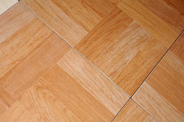 Photo Example of a floor tile. This floor tile is imitating a wooden floor and is available in 2 colors