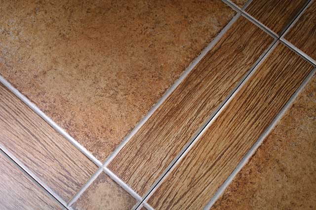 Photo example of a floor tile in a light beige brown color including some elements imitating wood tiles