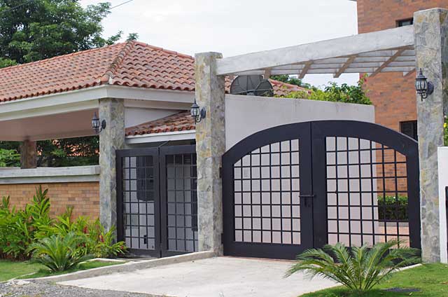 Example of a gate on a modern town house painted in black and made of metal