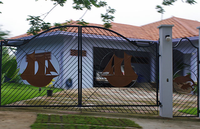 Photo of a black metal gate decorated with two sail ships