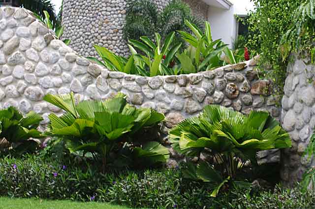 Photo example of a wall on a country home built with grey river stones