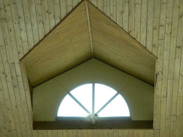 Photo example of a ceiling / roof window surrounded with wood paneling
