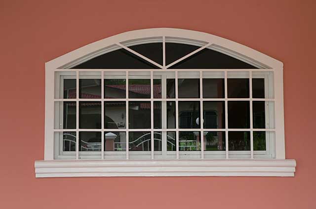 Photo example of a window with security metal square frames that makes it look like French style windows